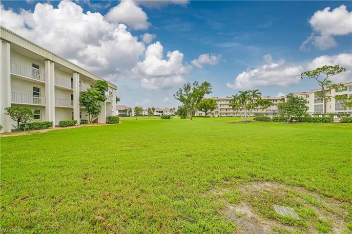 View of yard with a balcony