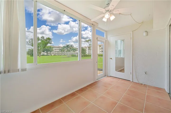 Unfurnished sunroom featuring ceiling fan