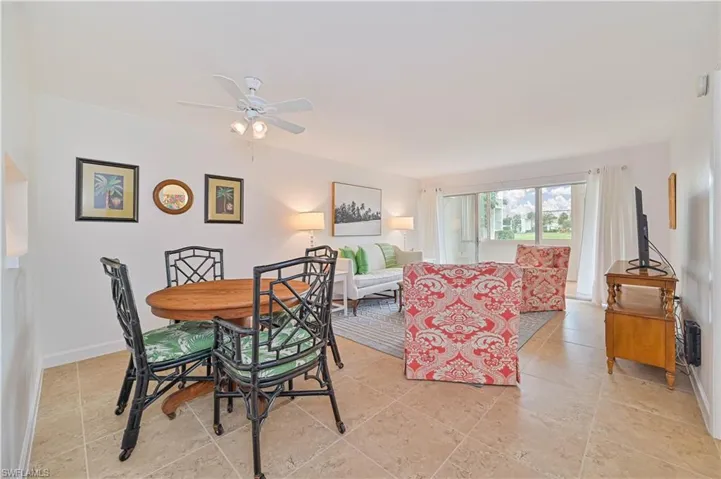 Dining area with light tile patterned floors and ceiling fan
