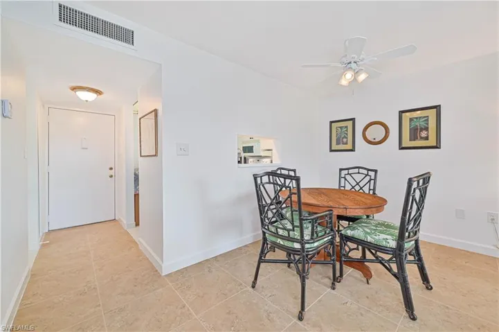 Tiled dining room with ceiling fan