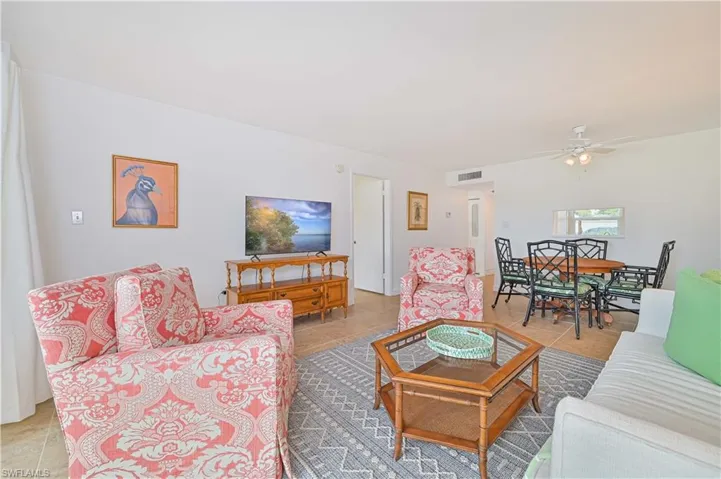Tiled living room featuring ceiling fan