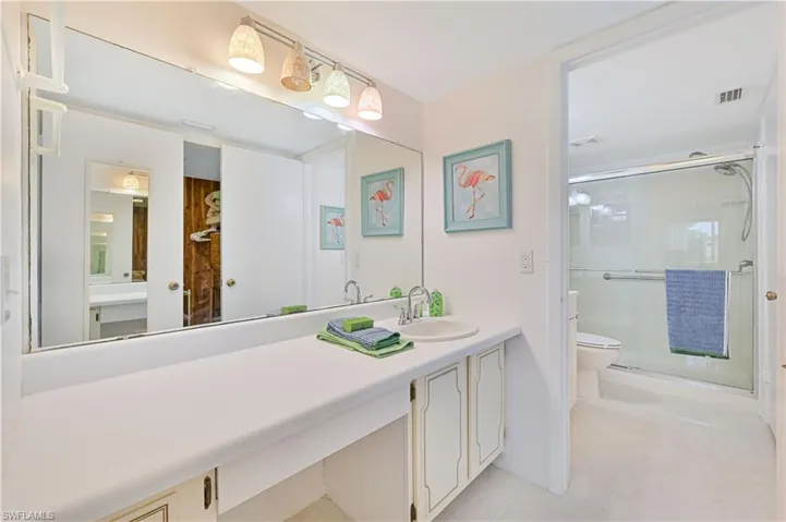 Bathroom featuring tile patterned flooring, toilet, and vanity