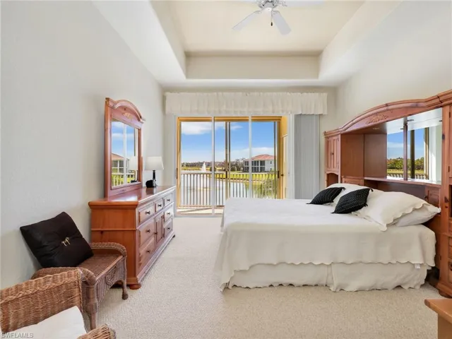 Primary Bedroom with sliders to the lanai. A beautiful view to wake up to !