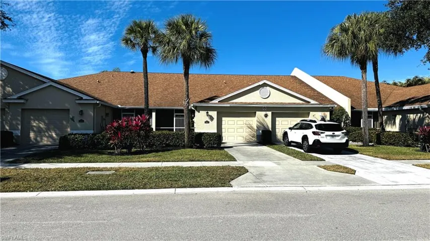 Beautifully maintained home with welcoming curb appeal and sunny Florida landscaping.