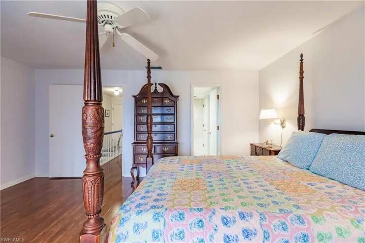 Bedroom featuring ceiling fan and dark hardwood / wood-style floors