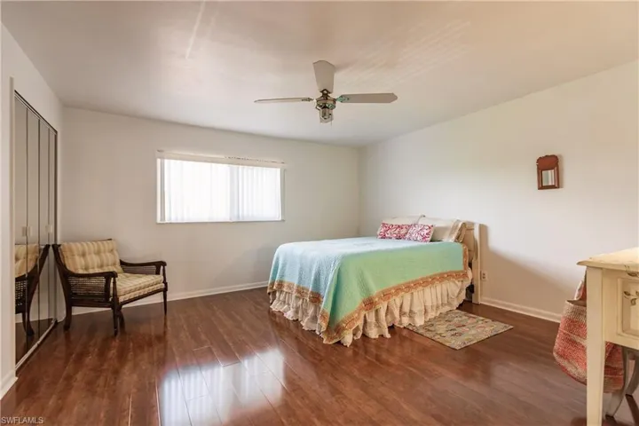 Bedroom featuring ceiling fan and dark hardwood / wood-style floors