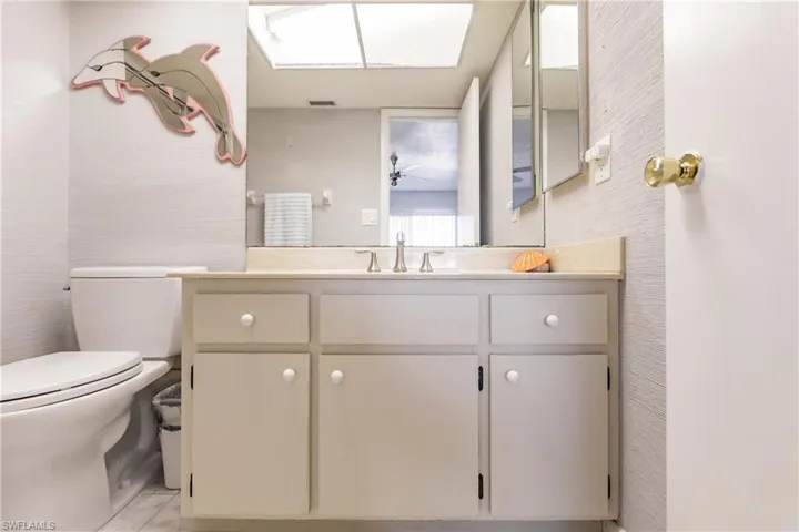 Bathroom featuring tile patterned flooring, vanity, and toilet