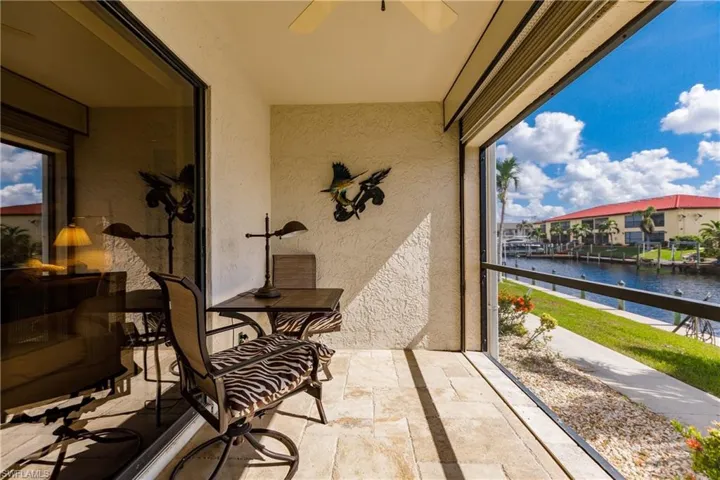 Sunroom / solarium with a water view and ceiling fan