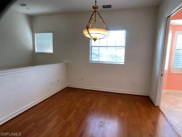Spare room featuring wood finished floors