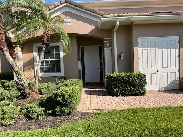 Property entrance featuring stucco siding