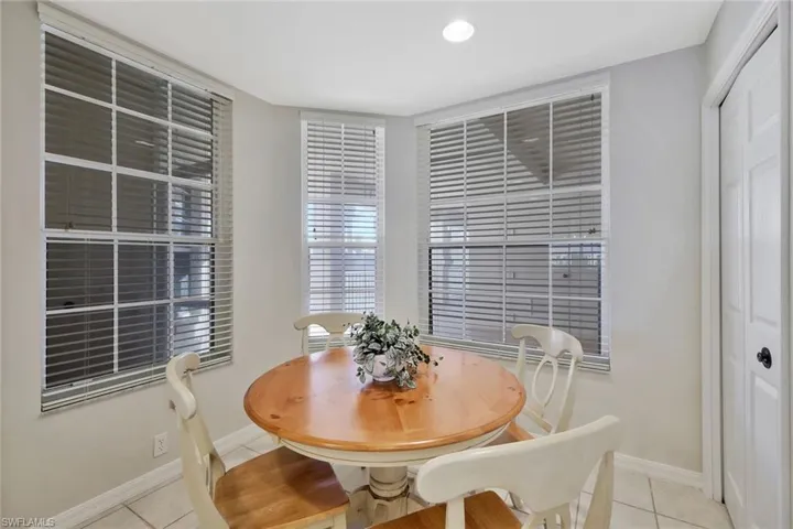 Dining room featuring light tile patterned flooring and baseboards