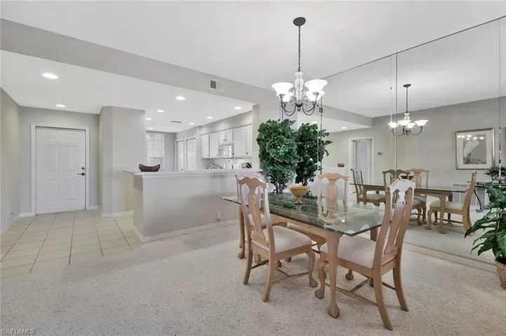 Dining area featuring a chandelier, recessed lighting, and light tile patterned floors