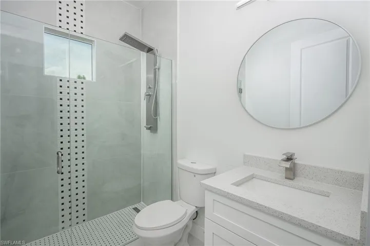 Full bathroom featuring vanity and a shower stall