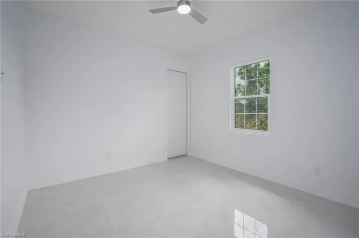 Empty room with baseboards and ceiling fan