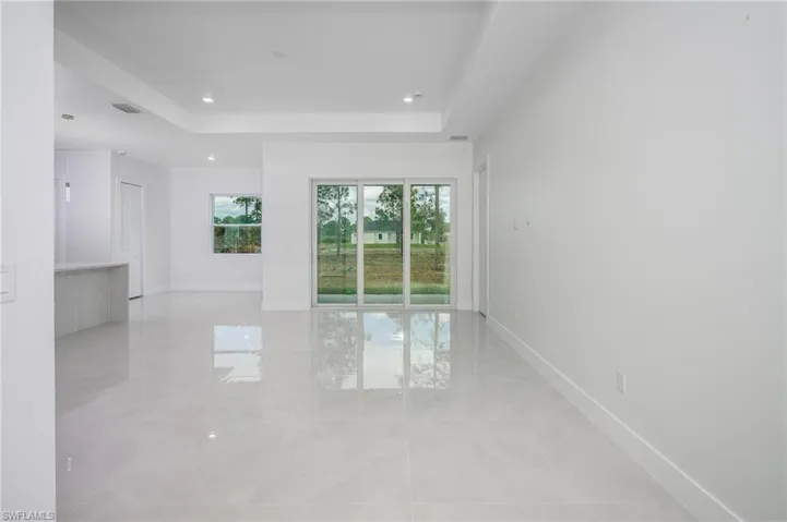 Unfurnished room with a tray ceiling and recessed lighting