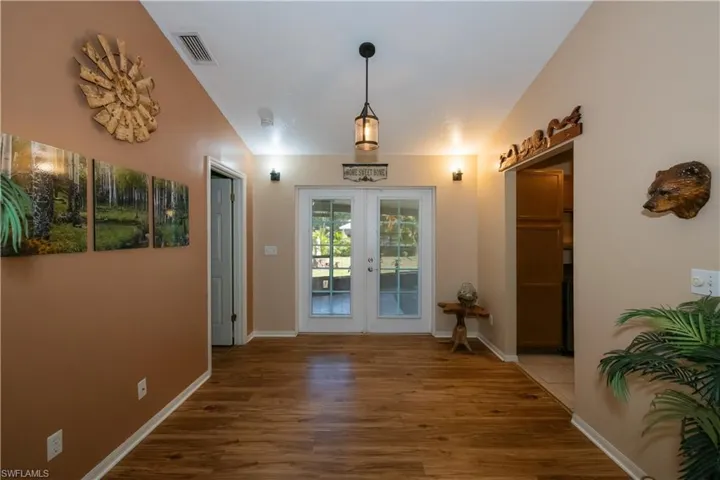 French doors to back porch, left to Master Bedroom and right to Kitchen