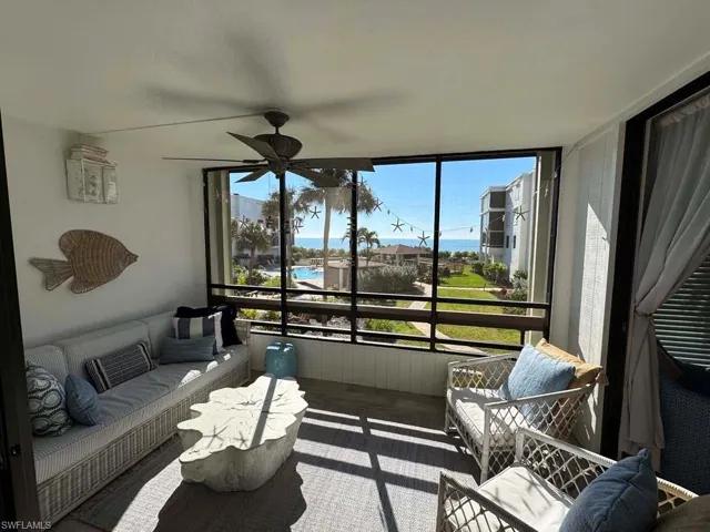 Sunroom with an outdoor hangout area, a balcony, a ceiling fan, and healthy amount of natural light