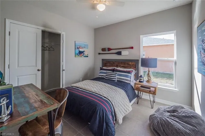Tiled bedroom featuring a closet and ceiling fan