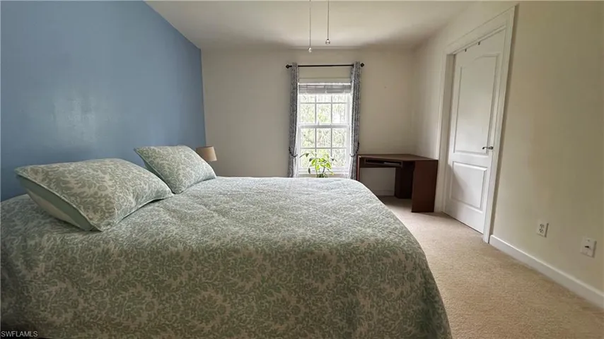 Bedroom with light colored carpet