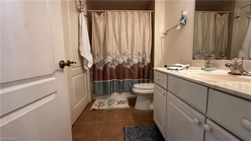 Bathroom with tile patterned floors, toilet, and vanity