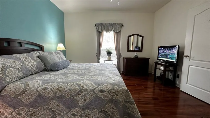 Bedroom featuring dark wood-type flooring