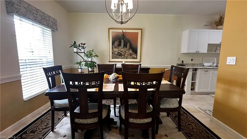 Dining area featuring a chandelier and light tile patterned floors