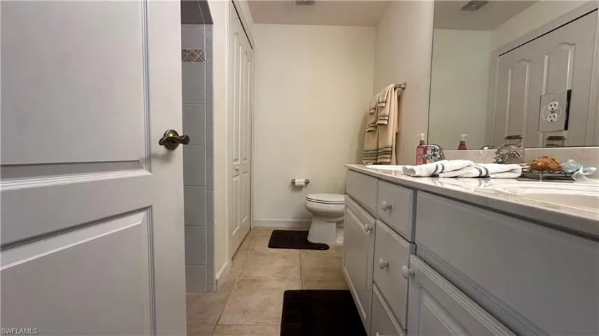 Bathroom featuring vanity, toilet, and tile patterned floors