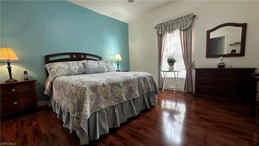Bedroom with dark wood-type flooring