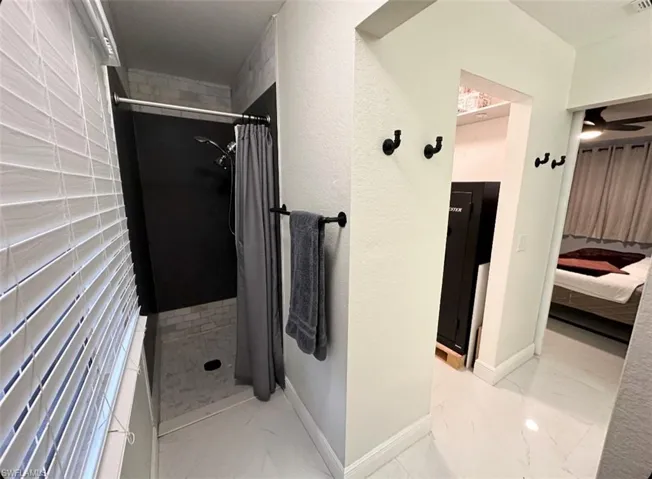 Bathroom with tile flooring and walk in shower