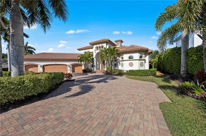 Front elevation with circular driveway and 4 car garage