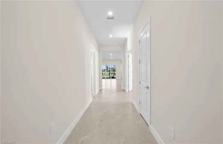 Hall with baseboards and recessed lighting