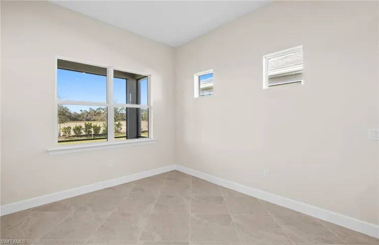 Unfurnished room with baseboards