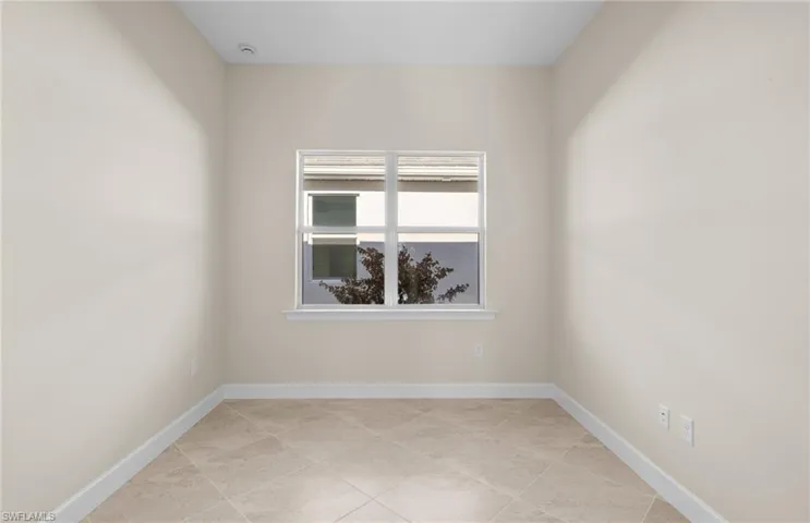 Empty room featuring baseboards
