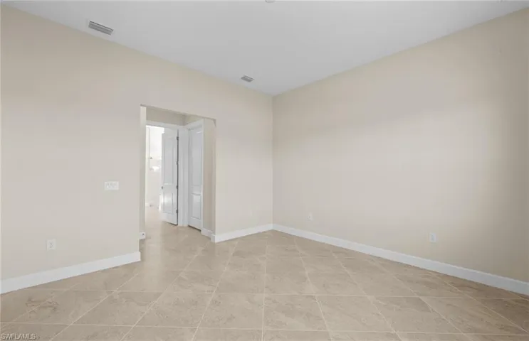 Spare room featuring baseboards