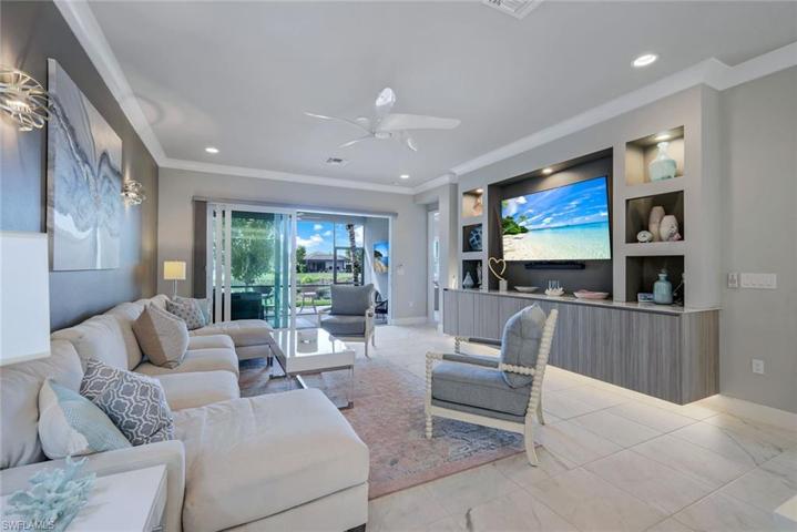 Notice the floating entertainment center with under cabinet lighting.