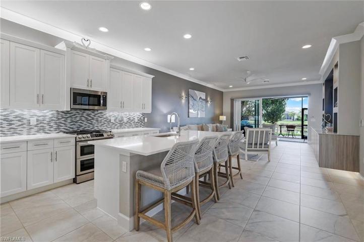 UPGRADED kitchen features shaker cabinets, under cabinet lighting, stainless appliances, quartz countertops & so much more!...