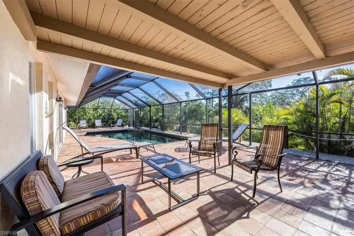 View of patio / terrace with an outdoor pool and glass enclosure