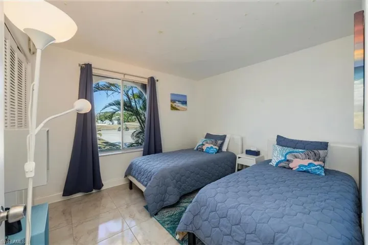 Bedroom featuring baseboards and marble finish floor