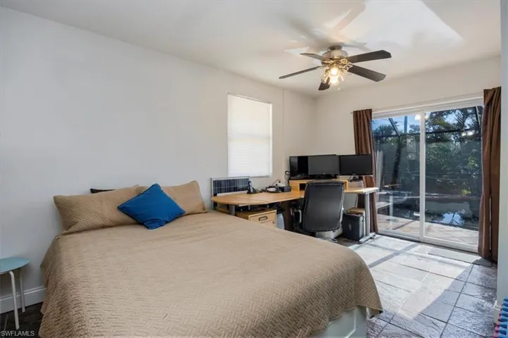 Bedroom featuring ceiling fan and access to outside