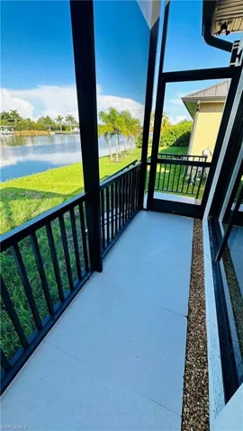 Screened outdoor patio featuring a concrete floor and black metal railing