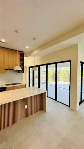 Kitchen island featuring a slatted wood-finish base and light-toned countertop