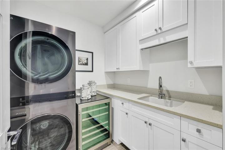 Large laundry room with laundry tub and SO MUCH STORAGE space.