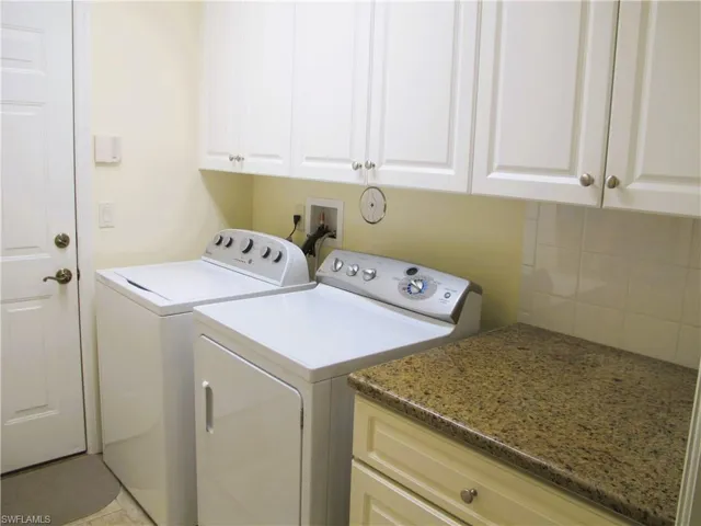 Laundry room with cabinet space and washing machine and dryer