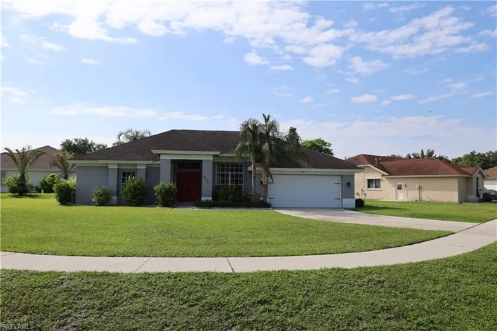 Single-story residence featuring a gray exterior, dark shingle roof, and a red front door