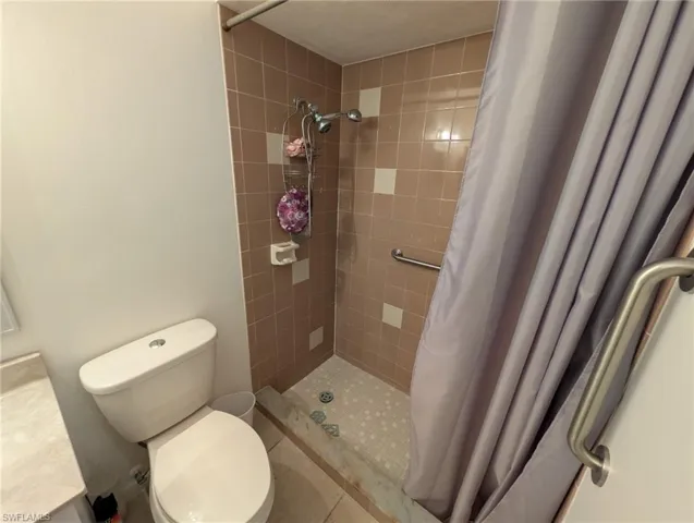 Full bath with a shower stall and vanity