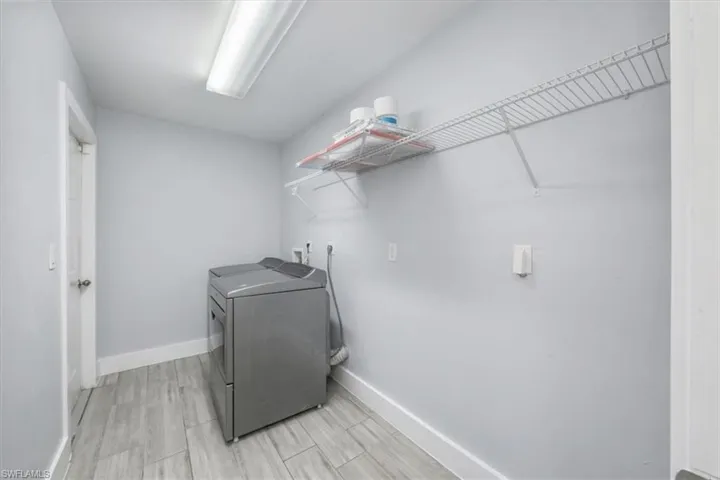 Laundry area featuring washer hookup, electric dryer hookup, and wood tiled floors