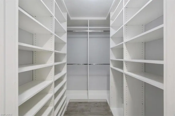 Spacious closet with light wood-style flooring