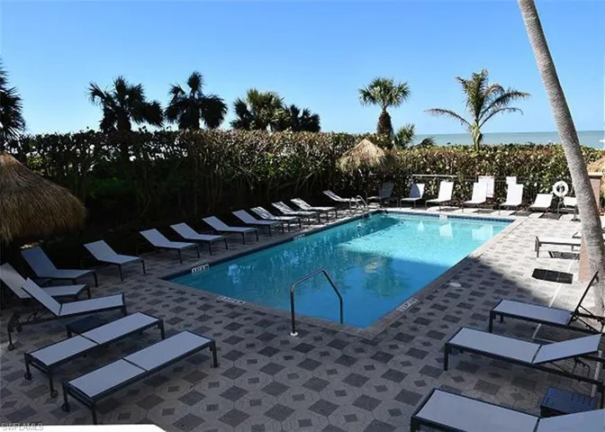 View of pool featuring a water view and a patio area