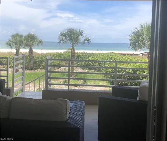 Balcony with a water view and a view of the beach