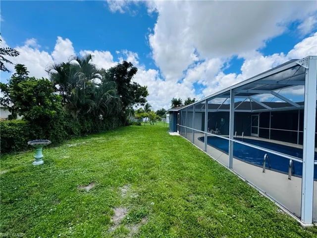 View of yard featuring glass enclosure